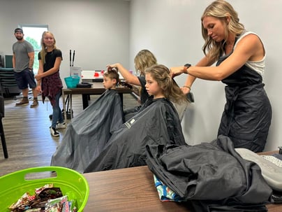 Little girl getting her haircut at a Back-to-School Haircut fundraiser | Vision to Venture: Recruiter Builds Immersion School for Children with Autism