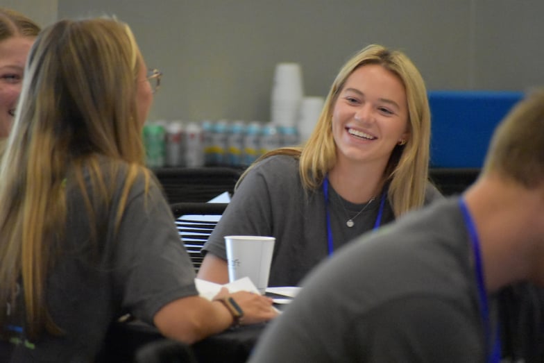 Student smiles during round table discussion at the Summer Leadership Program 2023