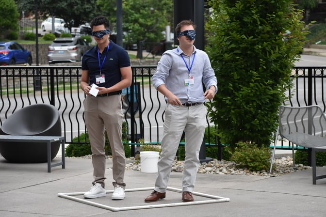 Two students stand blindfolded in the Three Islands team building game at the Summer Leadership Program 2023
