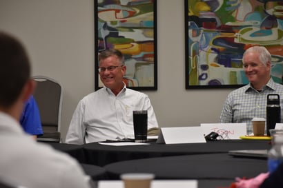 Brad Shaw, Managing Partner (left) smiles as he meets and provides guidance with Building Leaders participants as they identify their final group project | Blue Named Finalist for Chief Learning Officer’s LearningElite Status