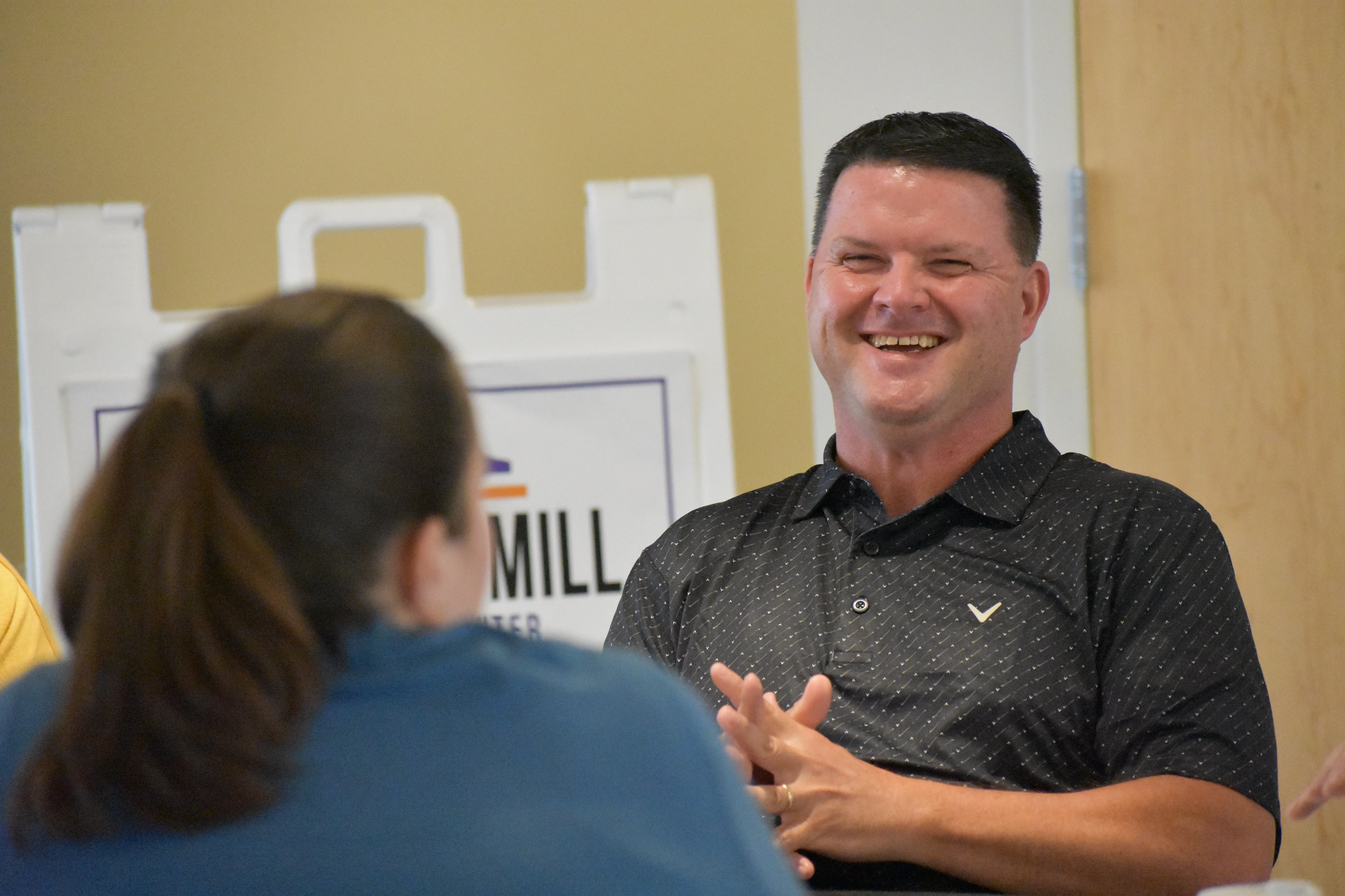 Shawn Wise smiles at Jill Moore while brainstorming ideas for their Building Leaders project | Talent Development Hosts Building Leaders Alumni Event in Cincinnati