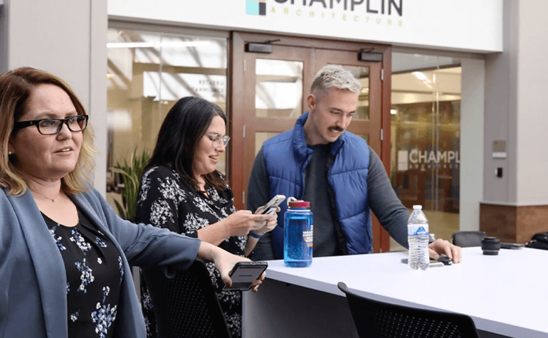 employees gathered around a desk - video thumbnail